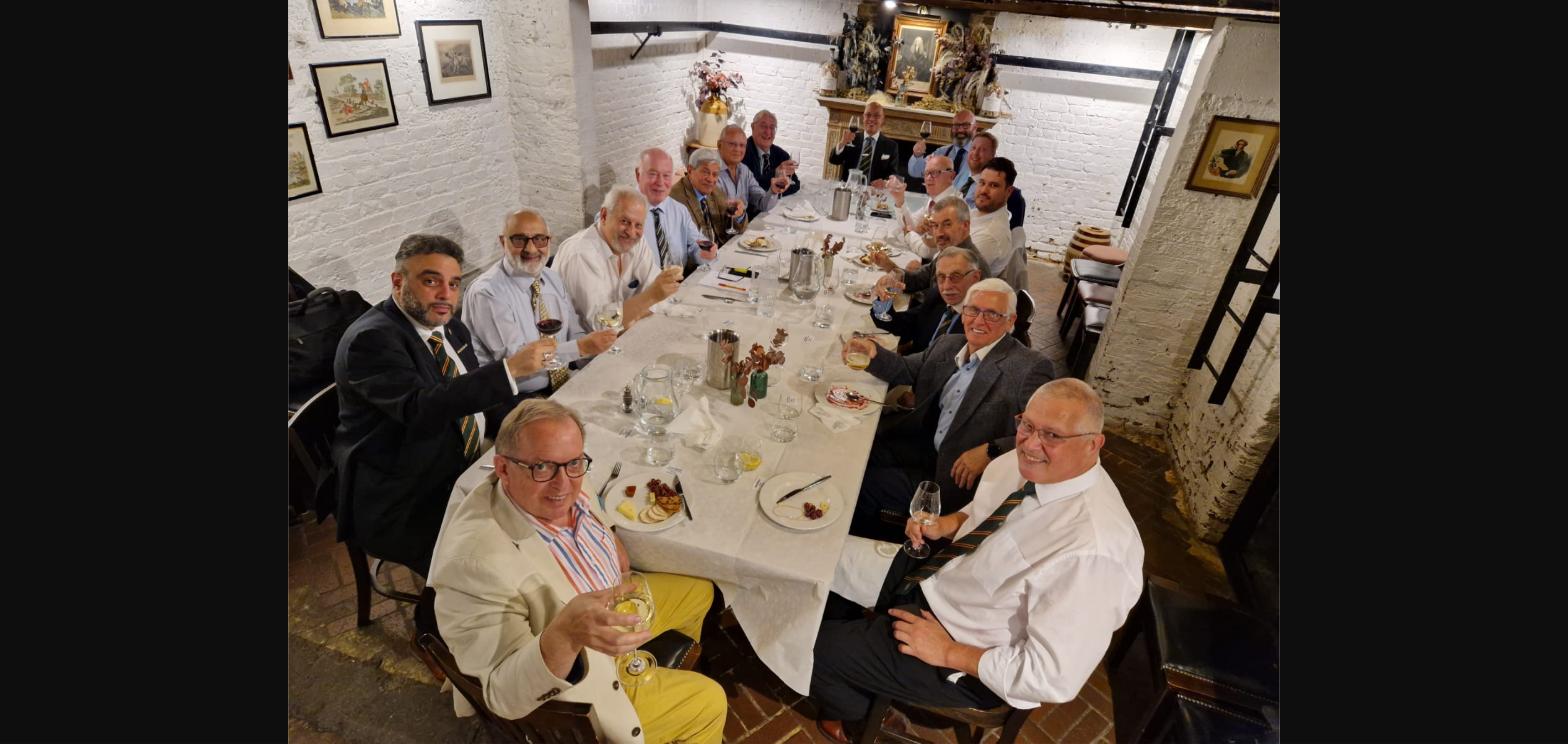 Group of AMD District of London members at the New Members' Dinner 2024, raising a toast at The Boot & Flogger